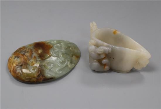 A Chinese white and russet jade vessel, Yi, and a celadon and russet jade pebble carving